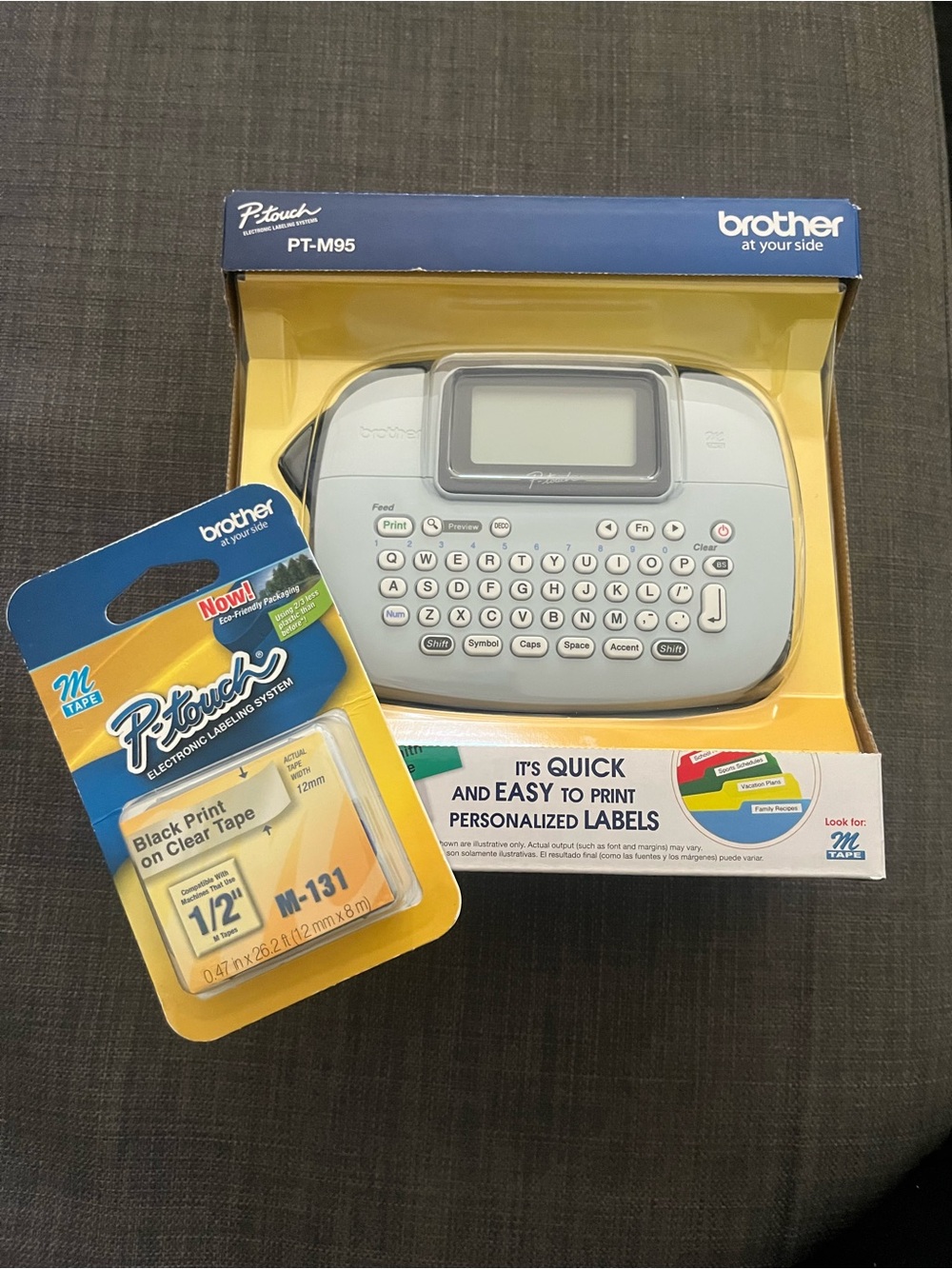 Brother PT-M95 Label Maker in Light Gray with Yellow Packaging